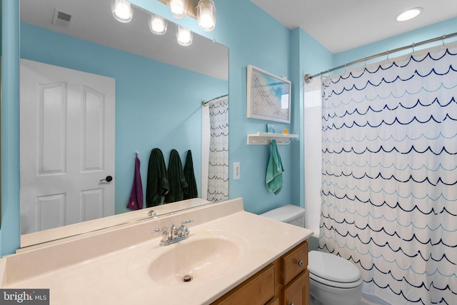 bathroom with vanity, toilet, and a shower with shower curtain