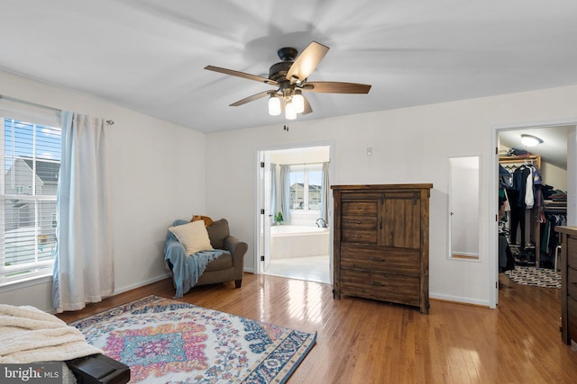 living area with light hardwood / wood-style flooring and ceiling fan