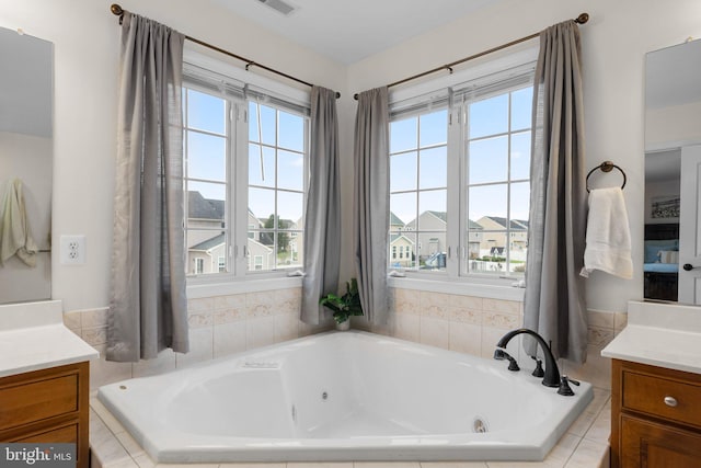 bathroom with vanity and tiled bath