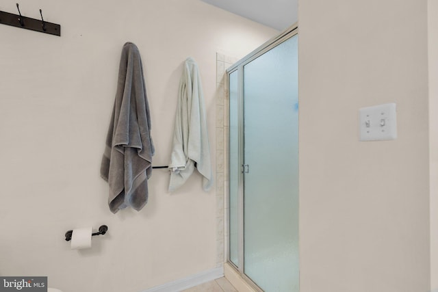 bathroom with a shower with shower door