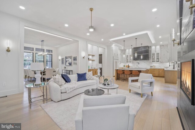 4428 Albemarle St NW, Washington, DC 20016 - living room with light wood finished floors, recessed lighting, and a chandelier