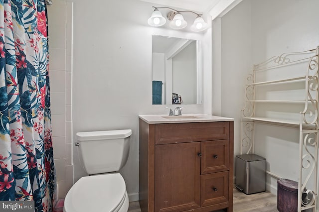 bathroom with vanity, toilet, hardwood / wood-style flooring, and a shower with curtain