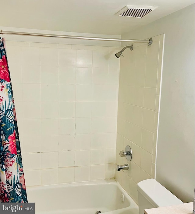 bathroom with toilet and shower / bathtub combination with curtain