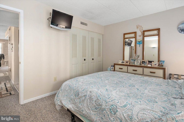 carpeted bedroom with a closet and a textured ceiling