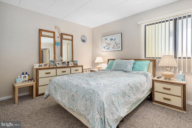 bedroom with a textured ceiling and light colored carpet