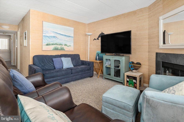 carpeted living room featuring a fireplace