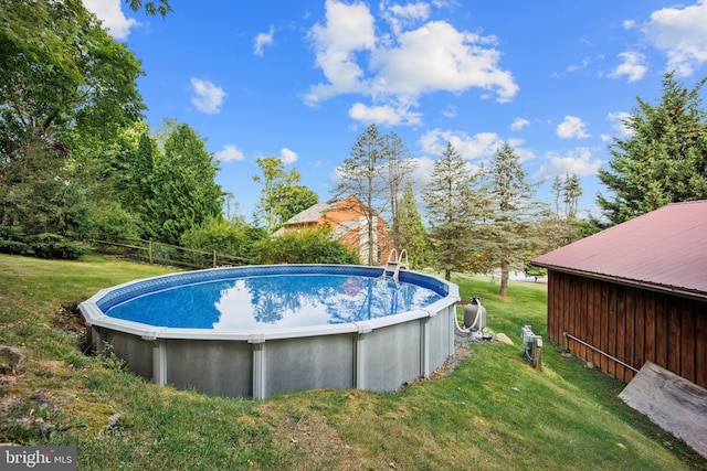 view of swimming pool with a lawn