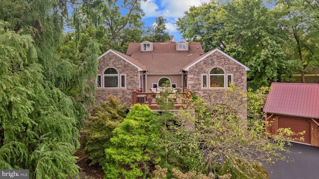 view of front of home with a wooden deck and a garage