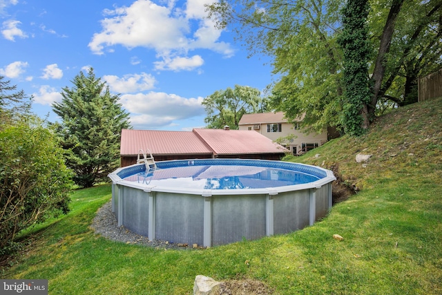 view of pool featuring a yard