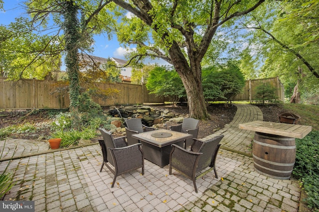 view of patio / terrace with an outdoor fire pit