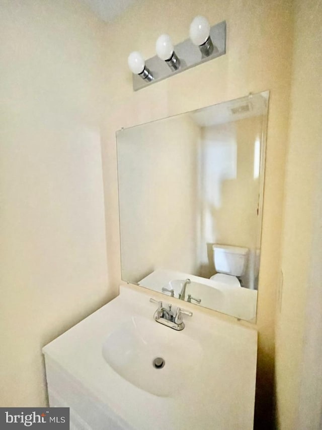 half bath with visible vents and vanity