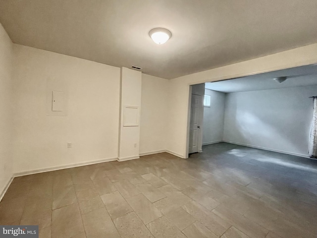 basement featuring baseboards and visible vents