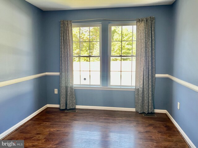 unfurnished living room featuring dark hardwood / wood-style flooring and ceiling fan