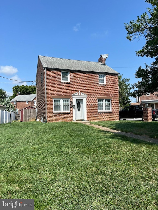 back of house featuring a lawn