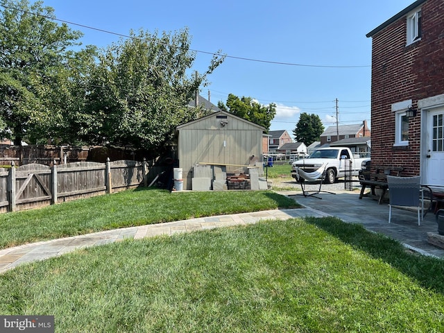 view of yard featuring a storage unit and a patio