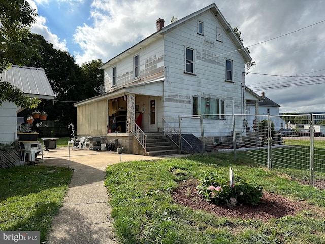 rear view of house with a lawn