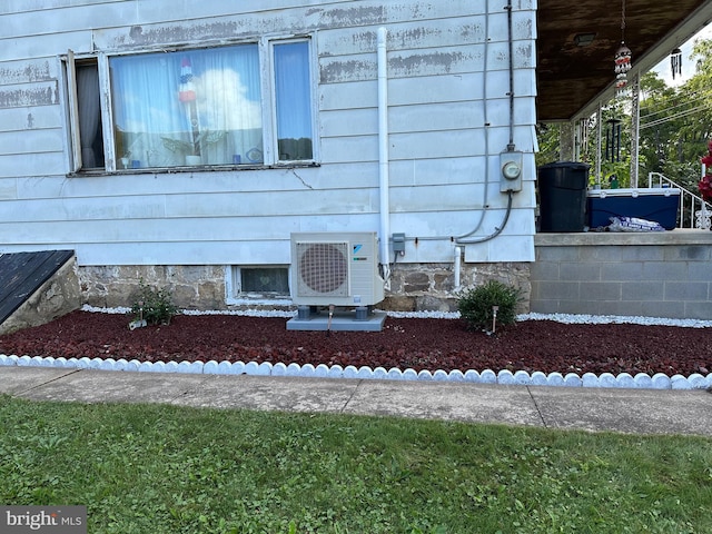 exterior details with ac unit and a wood stove