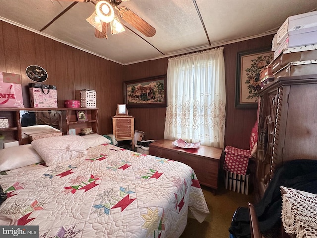 bedroom with ornamental molding, dark carpet, ceiling fan, and wood walls