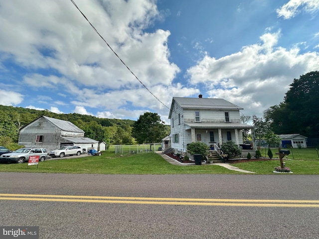 view of front of house featuring covered porch and a front yard