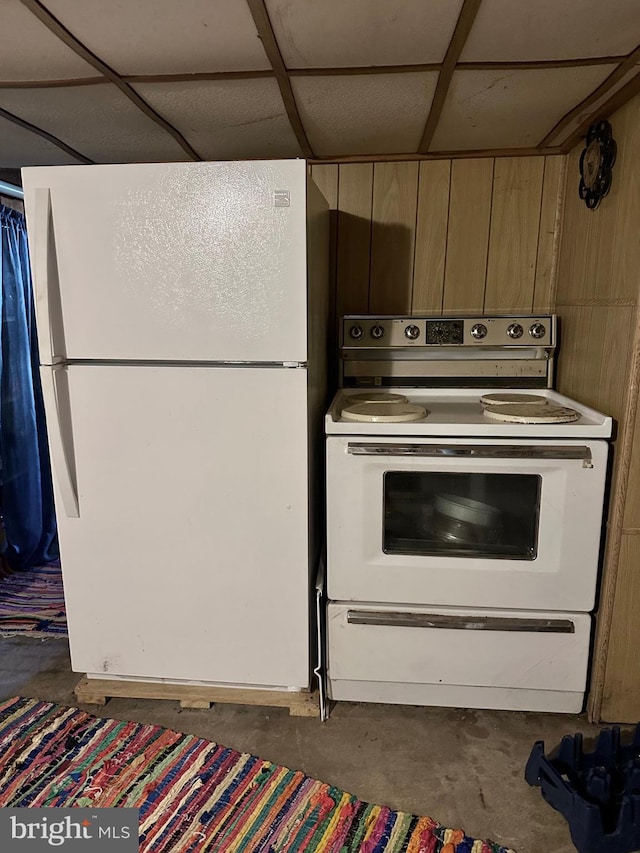 kitchen featuring white appliances and a paneled ceiling