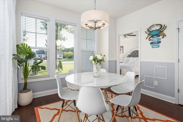 dining area featuring an inviting chandelier, baseboards, and wood finished floors