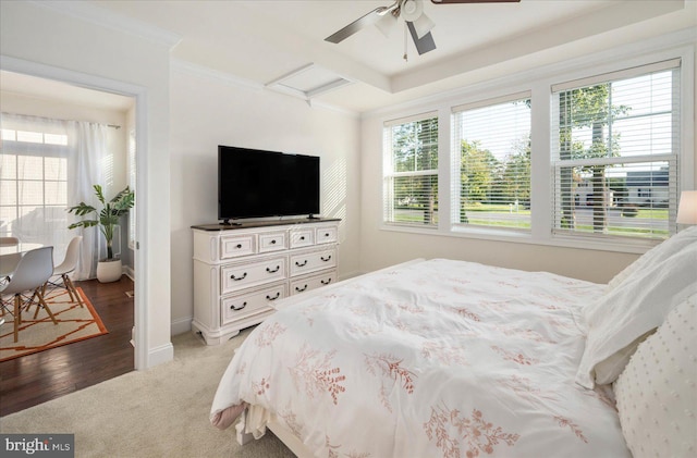 carpeted bedroom with attic access, baseboards, ceiling fan, and crown molding