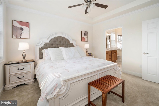 bedroom featuring ensuite bath, crown molding, light carpet, and ceiling fan