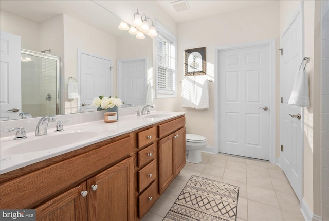 bathroom featuring tile patterned floors, toilet, an enclosed shower, and vanity