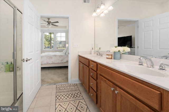 bathroom featuring a shower with door, vanity, ceiling fan, and tile patterned floors