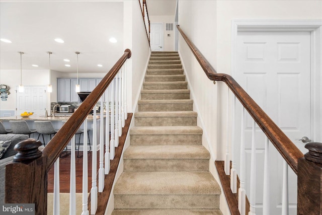 stairs featuring wood-type flooring