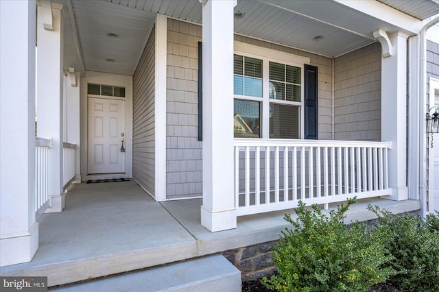 view of exterior entry with covered porch