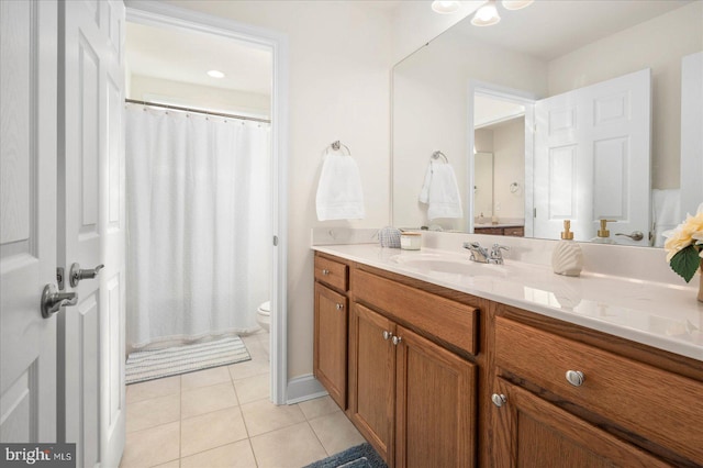 bathroom featuring vanity, toilet, a shower with curtain, and tile patterned flooring