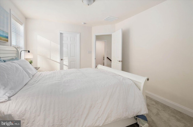 bedroom with visible vents, baseboards, and carpet flooring