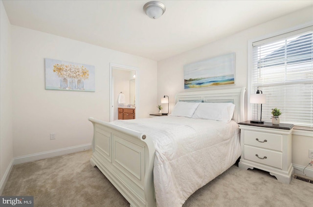 bedroom featuring light carpet, connected bathroom, visible vents, and baseboards