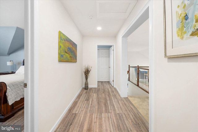 hallway with hardwood / wood-style floors