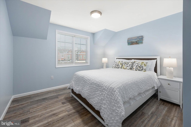 bedroom featuring baseboards and dark wood-type flooring