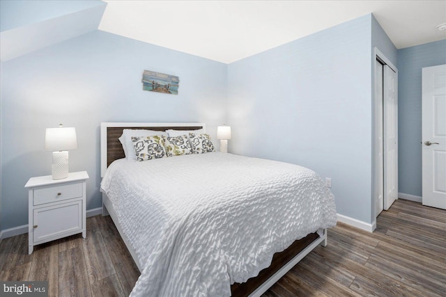 bedroom featuring a closet, baseboards, and wood finished floors