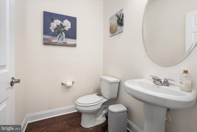 bathroom with hardwood / wood-style floors and toilet