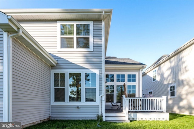 rear view of house with a wooden deck