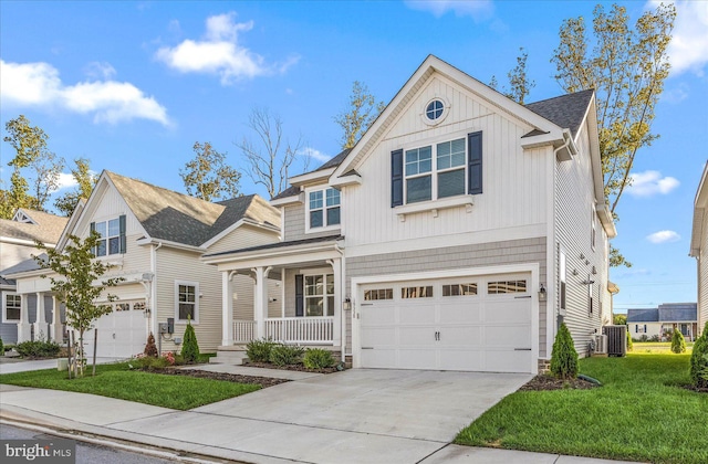 traditional-style house with a porch, cooling unit, a garage, driveway, and a front yard