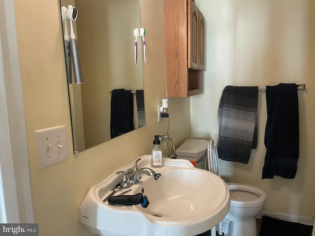 bathroom featuring toilet and sink