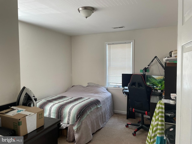 bedroom with light colored carpet