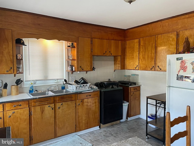 kitchen featuring white fridge, sink, and tasteful backsplash