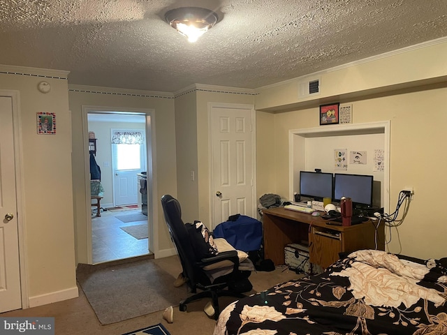 bedroom featuring ornamental molding and a textured ceiling