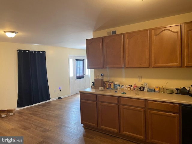 kitchen with dishwasher and dark hardwood / wood-style floors