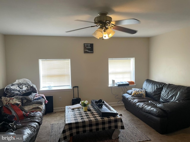 carpeted living room featuring plenty of natural light and ceiling fan