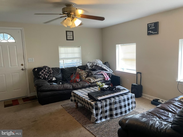 carpeted living room with a healthy amount of sunlight and ceiling fan