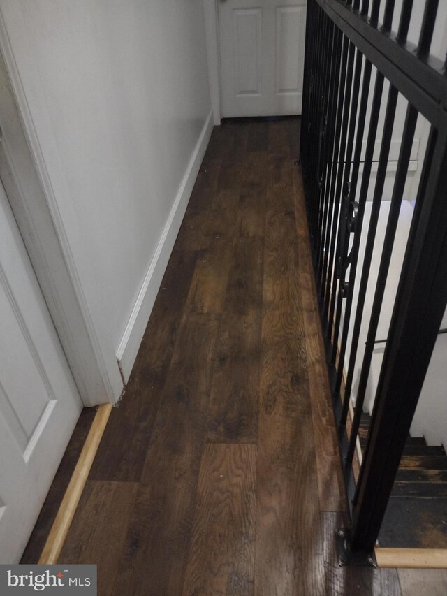 hallway with dark wood-type flooring