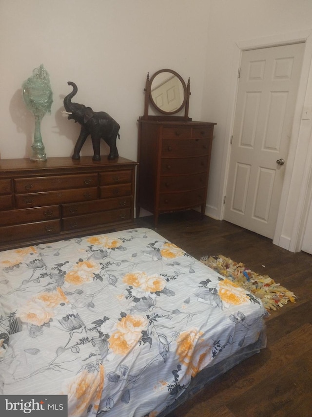 bedroom with dark hardwood / wood-style flooring