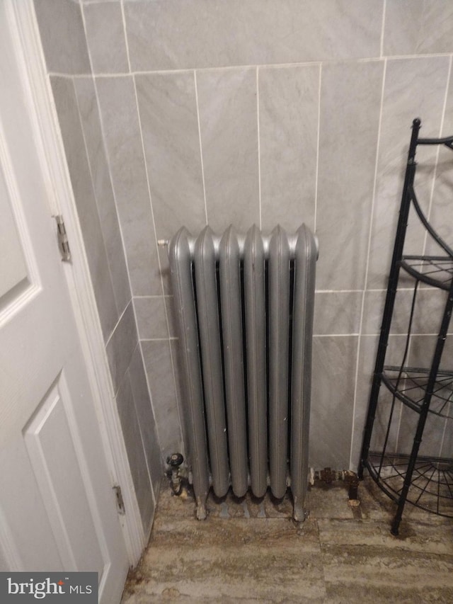 details featuring radiator heating unit and hardwood / wood-style flooring